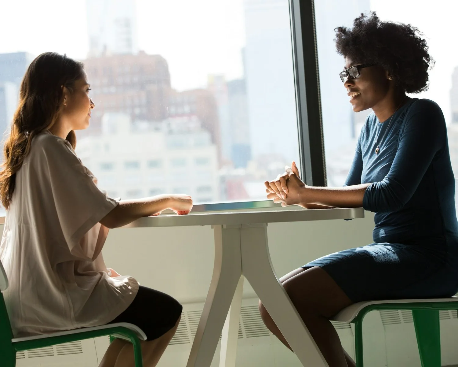 A careers adviser talking through options with a young woman across a table