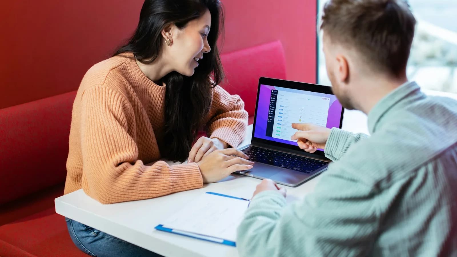 Two colleagues reviewing something on a laptop together